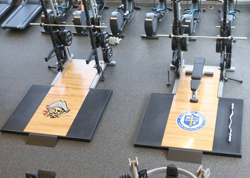 Ottawa High School and Marquette High School sponsored logos on bench presses at the Ottawa Dental Laboratory Wellness Center inside the new YMCA on Monday, May 6, 2024 in Ottawa.