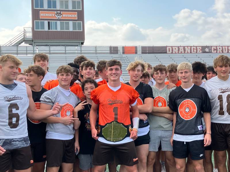 Hersey quarterback Colton Gumino holds his FridayNightDrive.com Team of the Week MVP belt with his Huskies teammates.