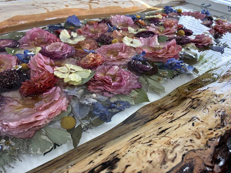 Dried flowers from a wedding arrangement at Bupp Woodworks & Designs on Nov. 28, 2025. The McHenry-based business encase the flowers in resin to preserve them.