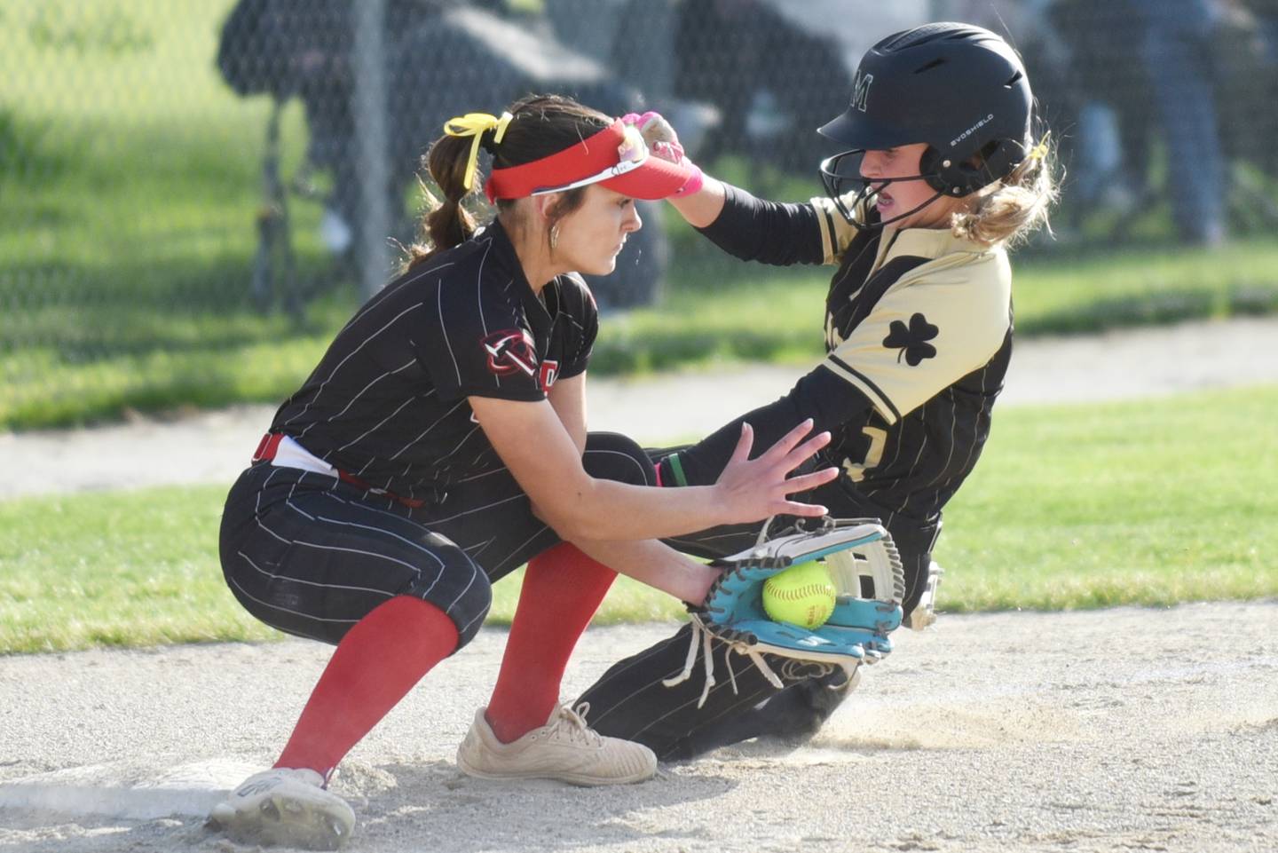 Bradley-Bourbonnais' Avery Moutrey, left, fields a throw at third base before tagging out a sliding Maddy Weiland of Bishop McNamara during a game at Bishop McNamara Thursday, May 7, 2026.