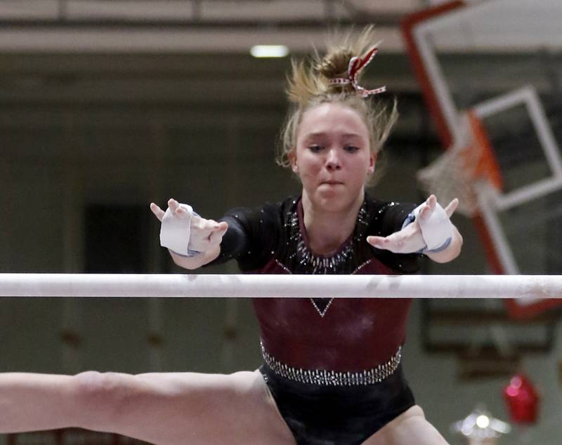 Prairie Ridge’s Bryleigh Cooper competes on the uneven parallel bars  during the IHSA Mundelein Gymnastics Sectional on Feb. 13, 2025, at Mundelein High School.
