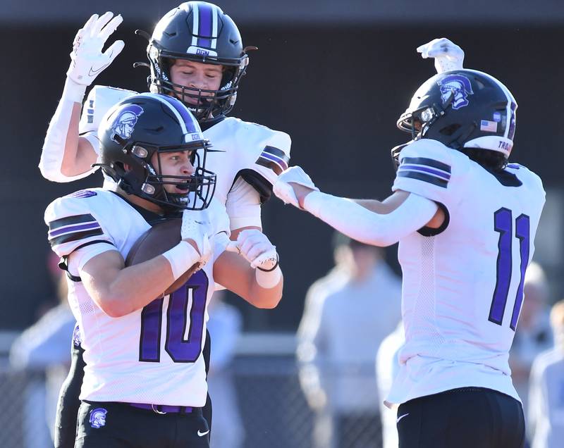 Downers Grove North's Oliver Thulin (10) celebrates with teammates Owen Thulin and Charlie Cruse (11) after his touchdown during an IHSA Class 7A quarterfinal game on Nov. 11, 2023 at Lincoln-Way West High School in New Lenox.