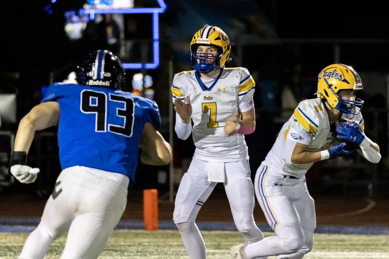 Sandburg's Luke Basiorka looks for an opening after accepting a hand-off from Sean Ruisz during a varsity football game against Lincoln-Way East at Lincoln-Way East on Oct. 23, 2025.