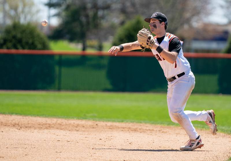 St. Charles East's Carter Laskowski (7) fields the ball and throws to first for an out against St. Charles North during a baseball game at St. Charles East High School on Saturday, May 7, 2022.