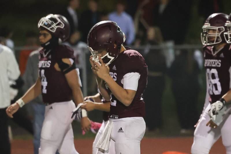A dejected Brendan Mecher leaves the field in Lockport’s overtime loss to Lincoln-Way West on Friday, Oct. 18, 2024 in Lockport.