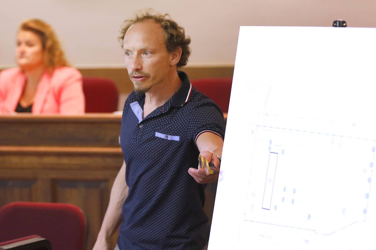 Zachary Zises, owner of 280E LLC, presents the plans for a proposed cannabis dispensary Thursday, Aug. 18, 2022, to a standing room only crowd attending a listening session at Richmond Village Hall. The proposal is set to be voted on by the Village Plan Commission at a meeting at 6 p.m. Monday, Aug. 22. Most the the residents at the listening session voiced their approval of the dispensary, but we opposed to the proposed location is at 5500 Swallow Ridge Drive, just off a busy stretch of Highway 12 just south of where Burlington Road branches off the highway.