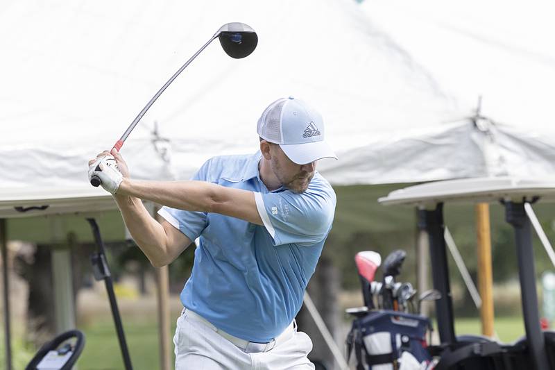 Joe Mills eyes the ball to start his round Sunday, July 21, 2024 during the final round of the 102nd Lincoln Highway golf tournament. The tournament was held at Emerald Hill in Sterling.
