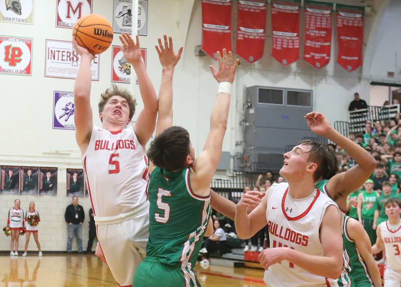Streator's Isaiah Weibel lets go of a shot over L-P's Erick Sotelo during the Class 3A Regional title game on Friday, Feb. 28, 2025 in Sellett Gymnasium at L-P High School.