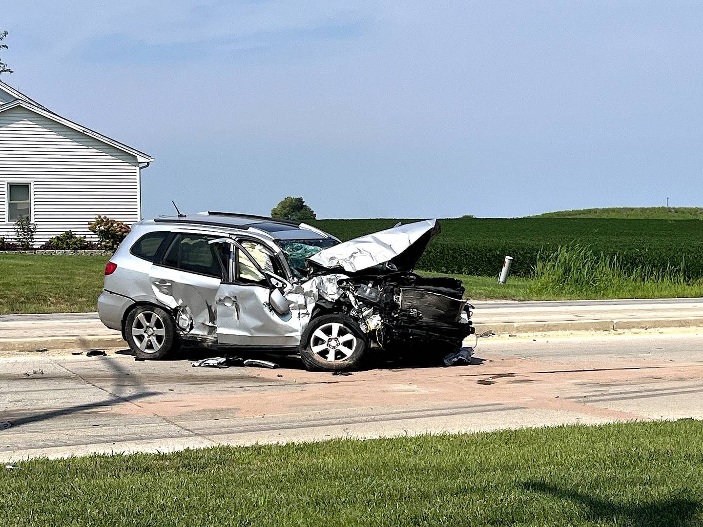 A destroyed Hyundai Santa Fe vehicle seen on Ridge Road in Joliet on Saturday, Aug. 16, 2025. The vehicle had struck a semitrailer, which overturned and spilled its large haul of rock on the roadway.