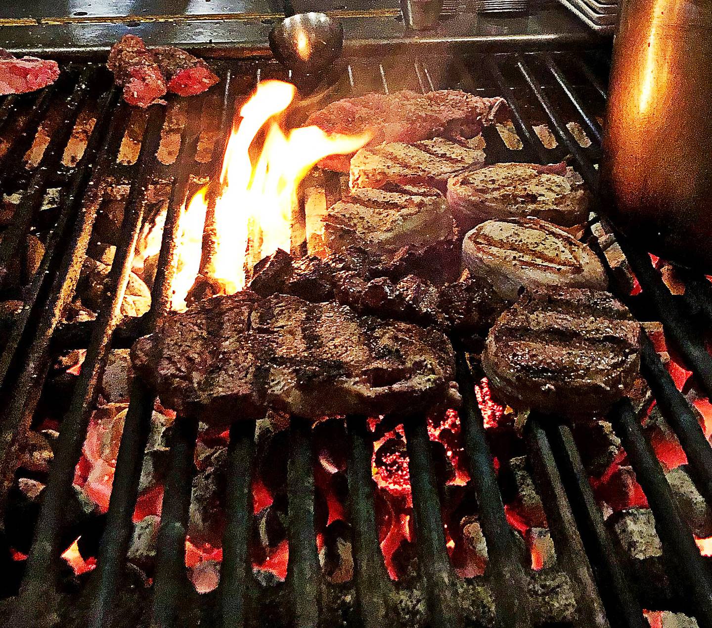 Steaks are grilled to perfection on a charcoal grill at Blackhawk Steak Pit in Oregon.