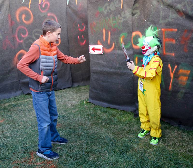 Elijah Lynch gets ready to fend off a scary clown in the Kamme-O-Circus Halloween Haunted House on Saturday, Oct. 19, 2024 in Elburn.