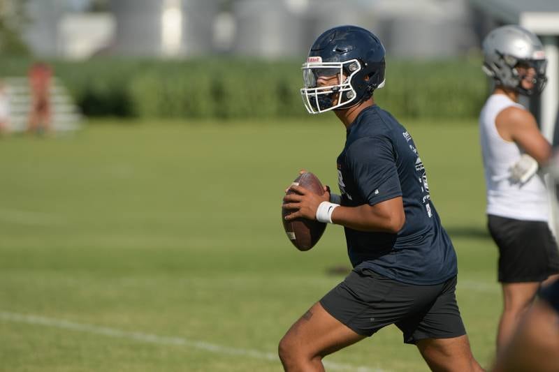 Oswego quarterback Cruz Ibarra looks for an open receiver during a 7 on 7 football against Burlington Central in Maple Park on Tuesday, July 12, 2022.