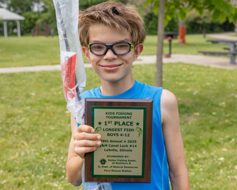 Dakota Lee poses with the plaque that he won for longest fish caught in the boys age four to twelve category at the 38th Annual Kid's Free Fishing Tournament on June 7, 2025 at Lock 14 in La Salle.