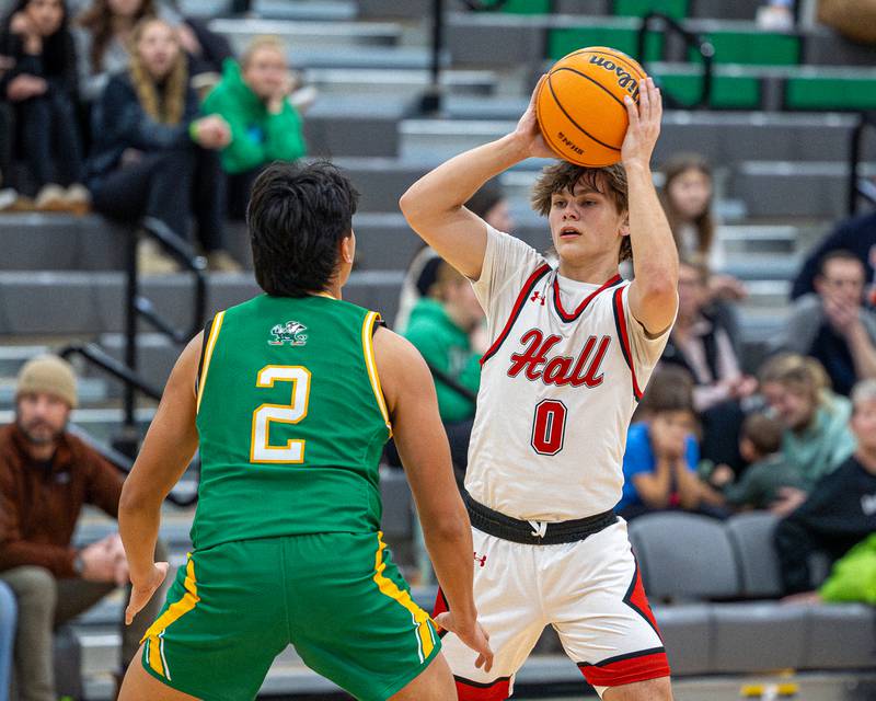 Greyson Bickett (0) of Hall holds ball above head looking for pass as Jesus Govea (2) of Seneca guards him in the Shipyard Showdown on Tuesday, December 23, 2025 at Seneca High School in Seneca.