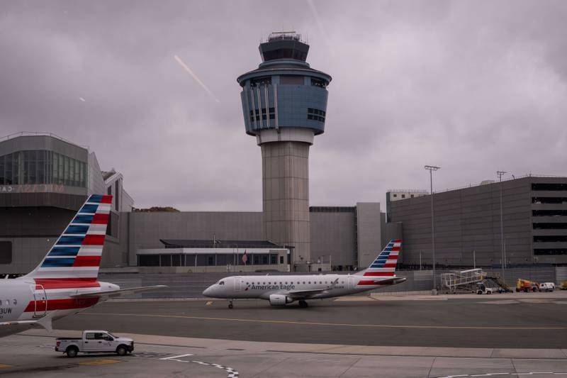 An American Eagle plane moves past the FAA Air Traffic Control tower at LaGuardia Airport (LGA) in the Queens borough of New York, Sunday, Nov. 9, 2025. (AP Photo/Adam Gray)