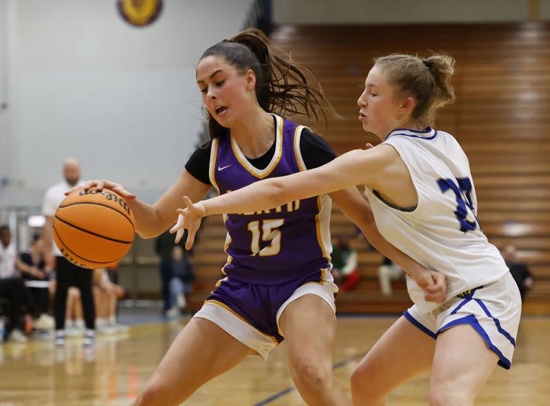 Downers Grove North'sAdysen Fanta (15) tries to get past Lyons' (20) Avery Mezan during the girls varsity basketball game between Downers Grove North and Lyons Township on Saturday, Jan. 11, 2025 in La Grange.