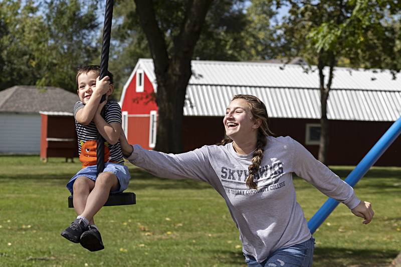 Molly Oliver gives Eldon Hubbell, 4, a shove on the new 100 foot zipline at Vaile Park in Dixon during the grand opening Thursday, Oct. 5, 2023.