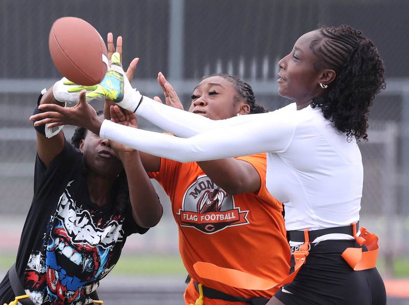 DeKalb’s Me’She Eubanks (right) tries to bring in a pass surrounded by heavy coverage Wednesday, Aug. 20, 2025, during the first practice of the DeKalb High School flag football team. The squad is preparing for their inaugural season.