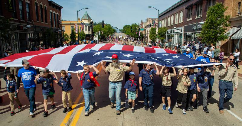 Scouts march with an American Flag during the St. Charles Memorial Day Parade in downtown St. Charles on Monday, May 26, 2025.