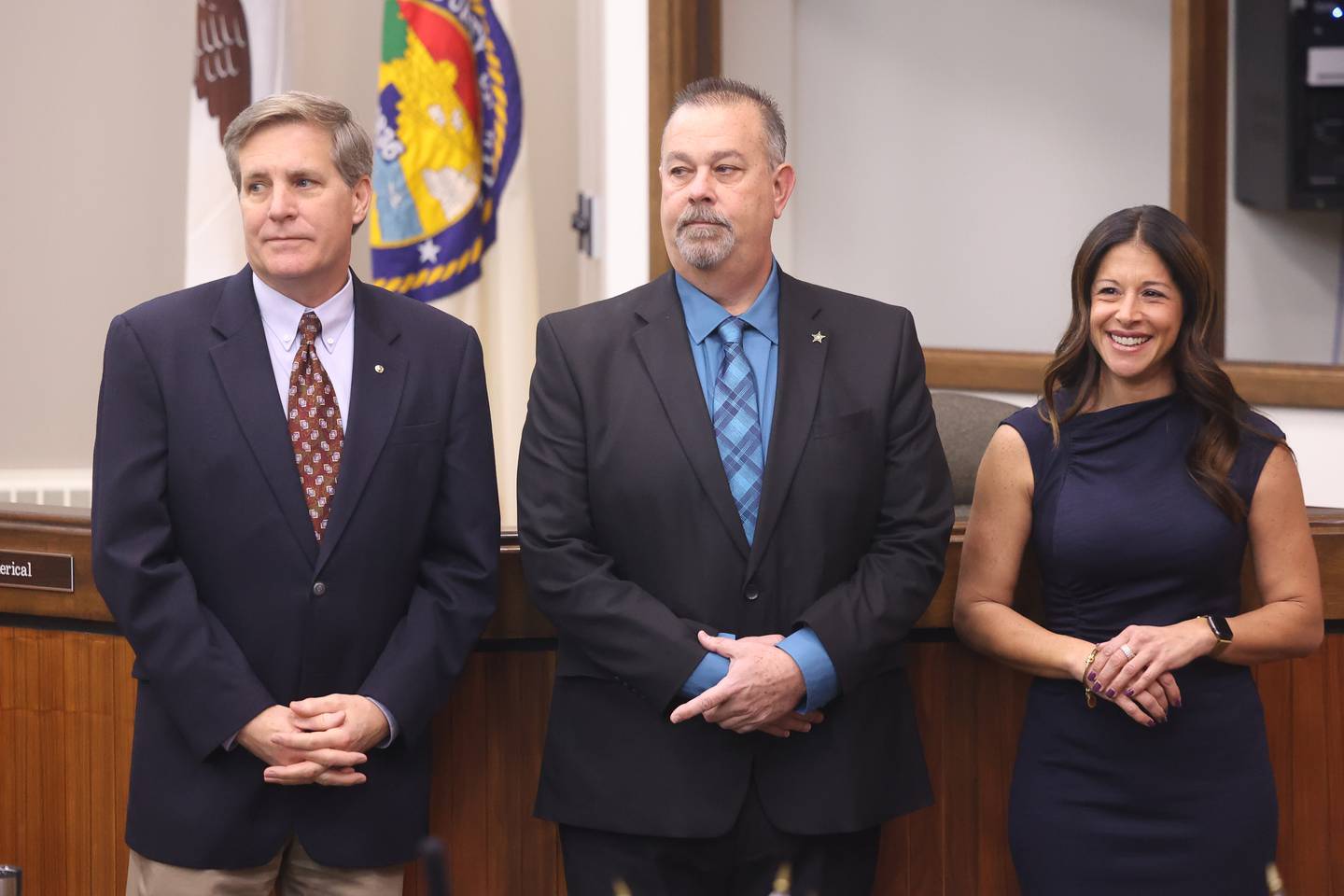Will County elected officials Tim Brophy, Mike Kelley and Lauren Staley-Ferry stand for their swearing-in ceremony at the Will County Building in Joliet on Thursday.