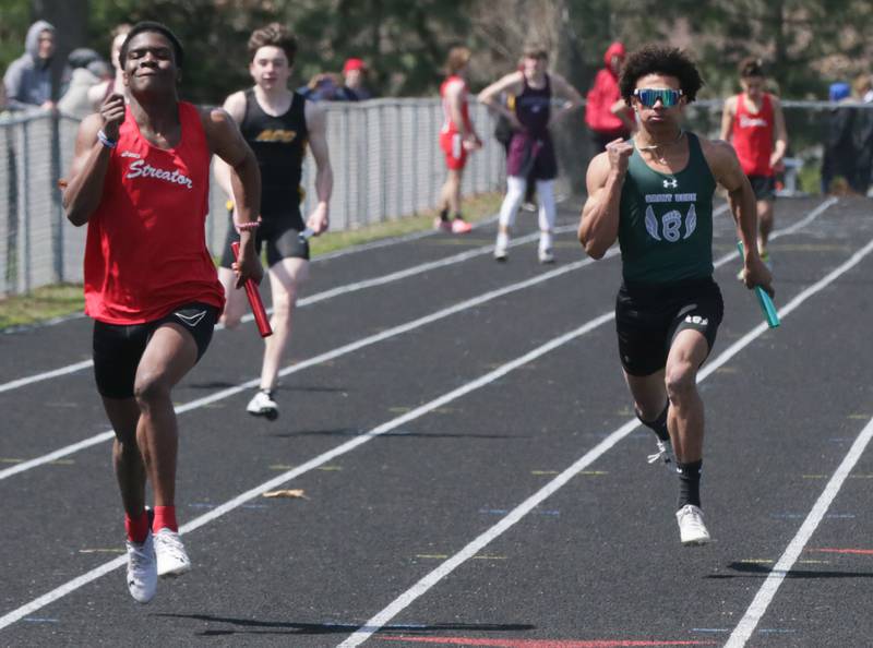 Streator's Aneefy Ford wins the boys 4x100 meter relay as St. Bede's Tyreke Fortney finishes second during the Rollie Morris Invite on Saturday, April 16, 2022 at Hall High School in Spring Valley.