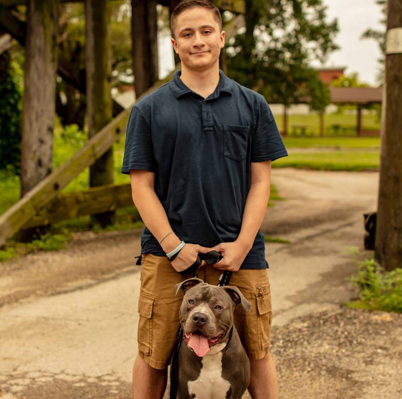 Landon McAlpine with his dog, Loki.