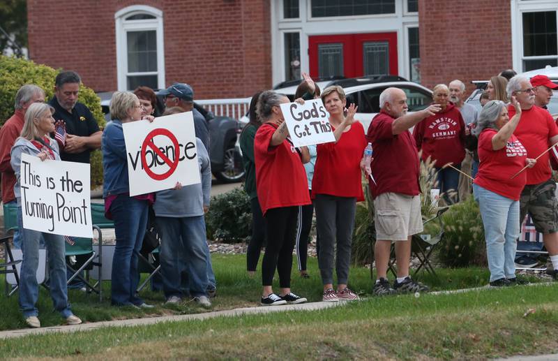 Supporters stand holding signs during A Night of Hope and Utity in honor of Charlie Kirk's birthday on Tuesday, Oct. 14, 2025 at City Hall Park in Princeton. The hour-long gathering paid tribute to Charlie along with standing up for peace, school shootings, violence and division.