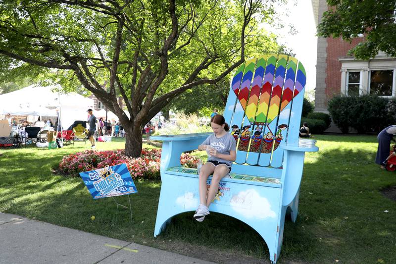 Ten-year-old Faye Jordan of Riverside relaxes in an oversized chair during the weekly farmer’s market in La Grange on Thursday, July 20, 2023.