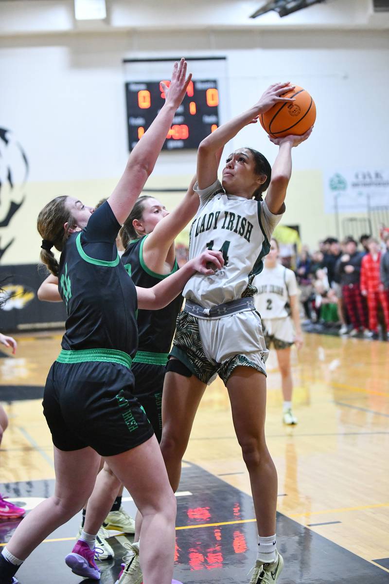 Bishop McNamara's Jaide Burse shoots under pressure from Seneca defenders during the Fightin' Irish's 51-30 victory over Seneca in the IHSA Class 2A Herscher sectional semifinal on Tuesday, Feb. 25.