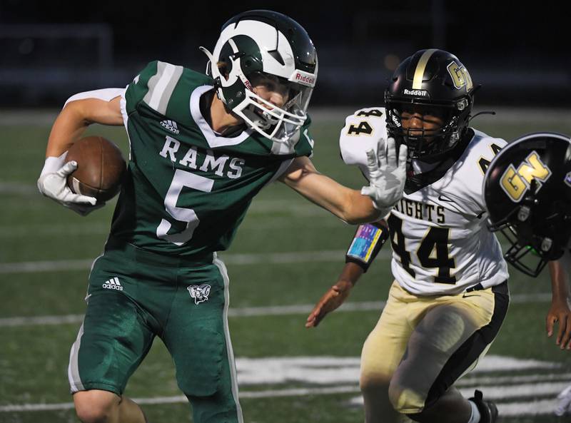 Grayslake Central’s Colton Ohm tries to get past Grayslake North’s Elijah Ayivi and Alan Jalloh after a reception in a football game at Central High School on Thursday, September 14, 2023.