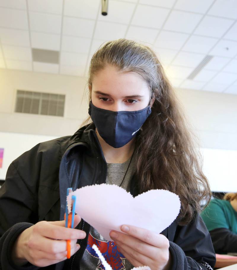Genoa-Kingston High School sophomore  Maddy Schroeder makes a Valentines Day card Tuesday, Jan. 25, 2022, in the library at the school. The cards students are making will be part of “Valentines for Seniors,” a card drive for local seniors living in residential care facilities, sponsored by State Representative Jeff Keicher, R-Sycamore, and State Senator Dave Syverson R-Rockford.