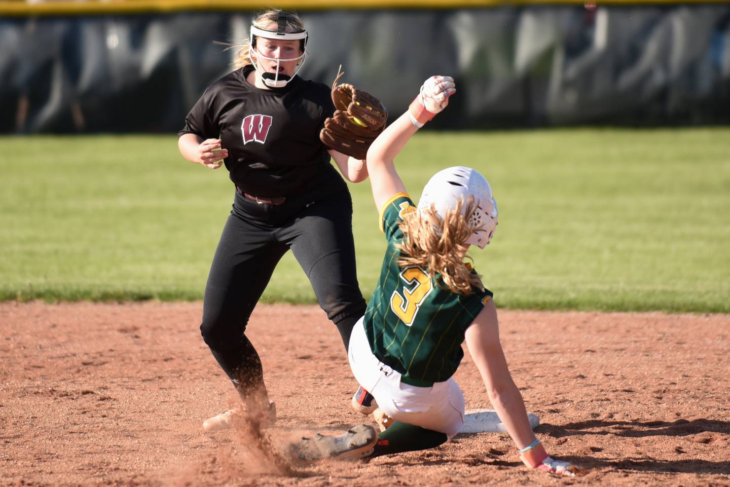 Watseka's Noelle Schroeder, left, reaches to tag Grant Park's Delaney Heldt out at second during a game at Grant Park Wednesday, April 22, 2026.