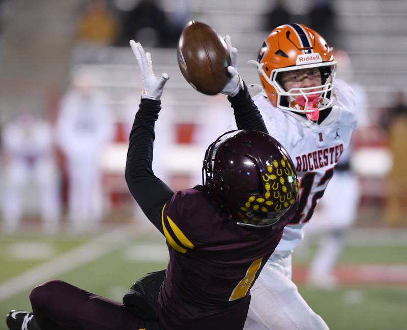 Montini's Damacio Ortegon catches a pass in front of Rochester's Nate Swaney during the IHSA Class 4A state championship game on Friday, Nov. 28, 2025 in Normal.
