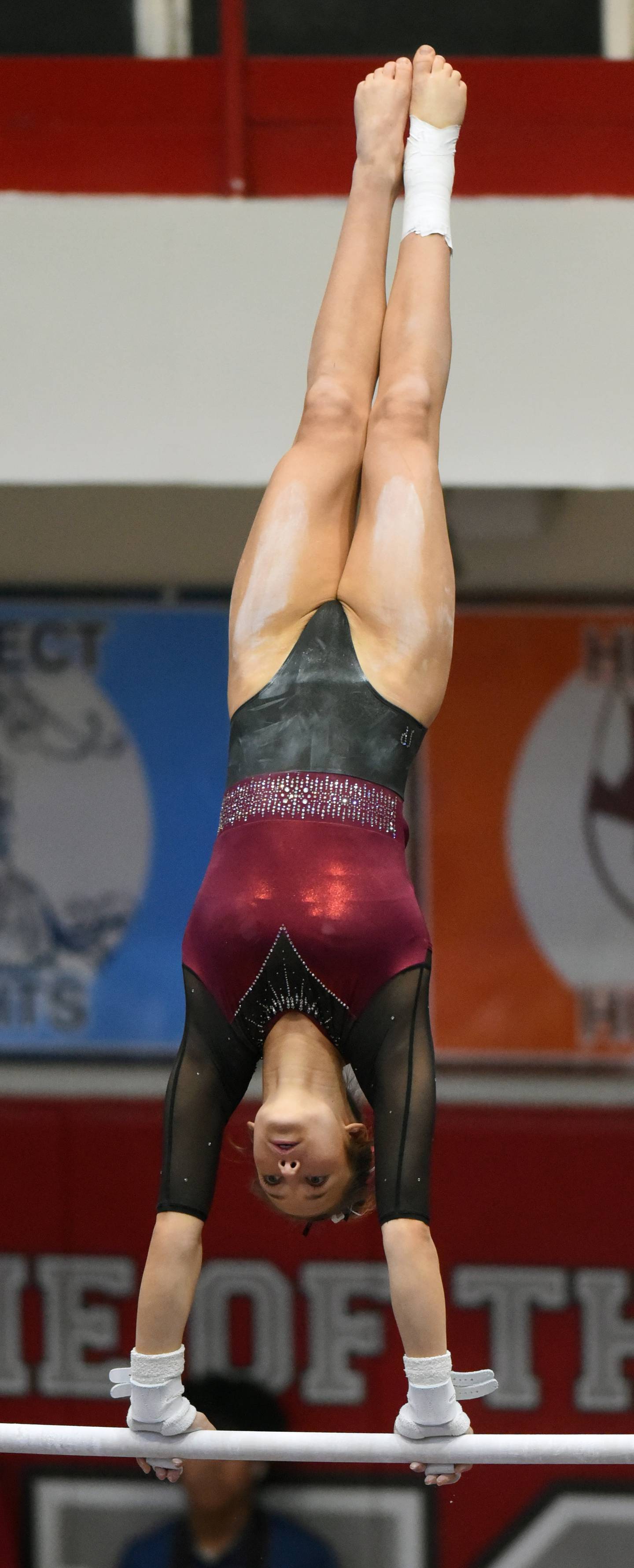 Nora Terhaar of Prairie Ridge competes on uneven parallel bars during the girls state gymnastics meet at Palatine High School on Saturday, Feb. 22, 2025.