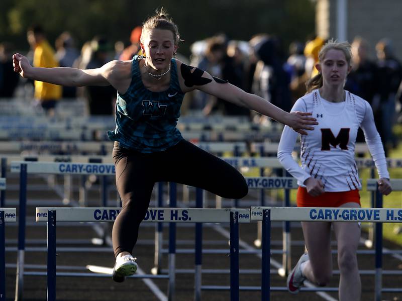 Woodstock North’s Bella Borta flies over a hurdle on the way to winning the 100 meter hurdles on Friday, April 19, 2024, during the McHenry County Track and Field Meet at Cary-Grove High School.