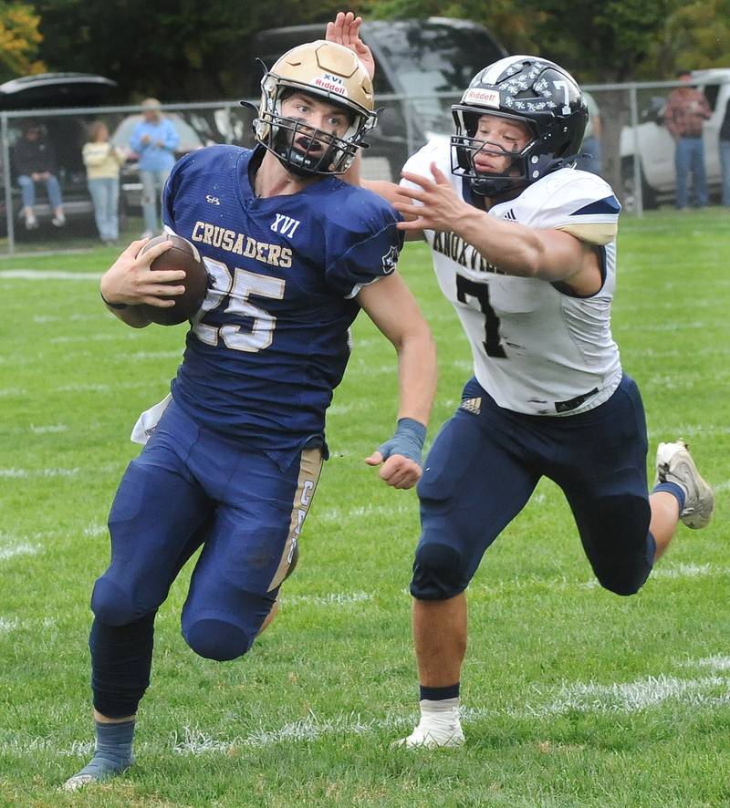 Marquette’s Jansen Higgins escapes the tackle attempt of Knoxville’s Brydon 
Walters during the 2nd quarter Saturday at Marquette.