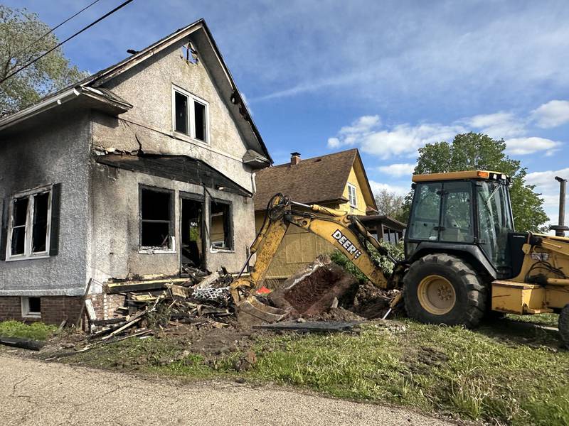 A backhoe begins to demolish a home located in the 800 block of Bucklin Street on Thursday, May 7, 2026 in La Salle. The home was destroyed by a fire on Jan. 23. Firefighters worked together to battle the blaze in subzero temperatures.
