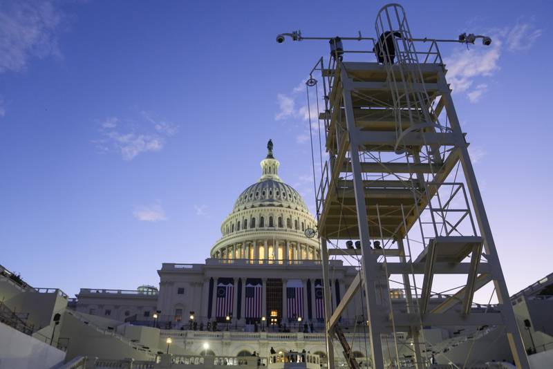 The sun rises behind the U.S. Capitol as a rehearsal takes place on the West Front ahead of President-elect Donald Trump's upcoming inauguration, Sunday, Jan. 12, 2025, in Washington.