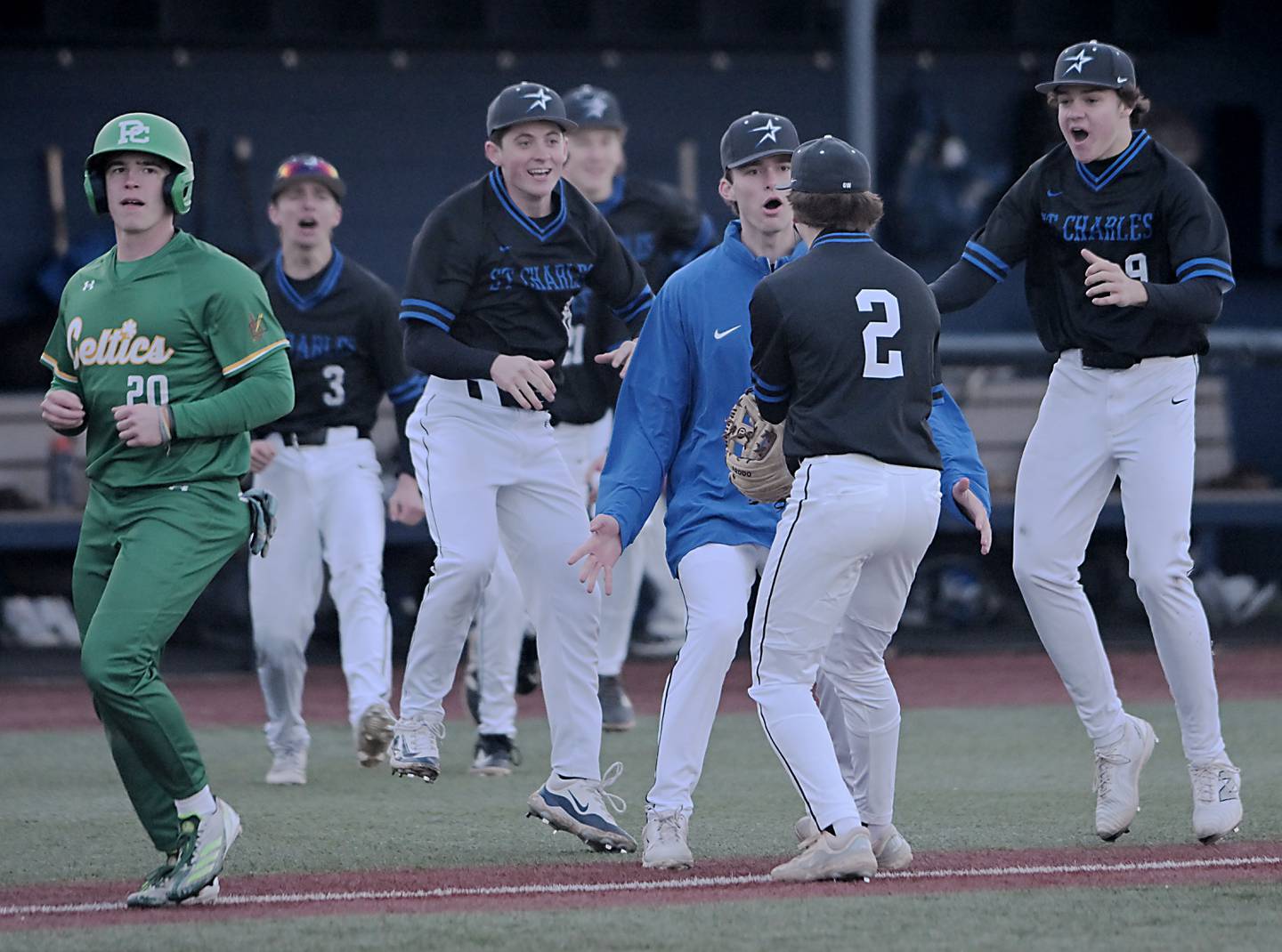 The St. Charles North bench greets pitcher Ben Auer after he finished the game against Providence Catholic in a baseball game at Wheaton College on Tuesday, March 25, 2025.
