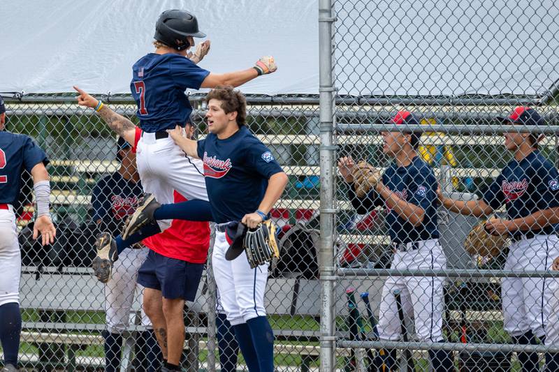 Jake Edlund (7) of Illinois celebrates scoring run with team on Thursday, July 17, 2025 at Washington Park in Peru.