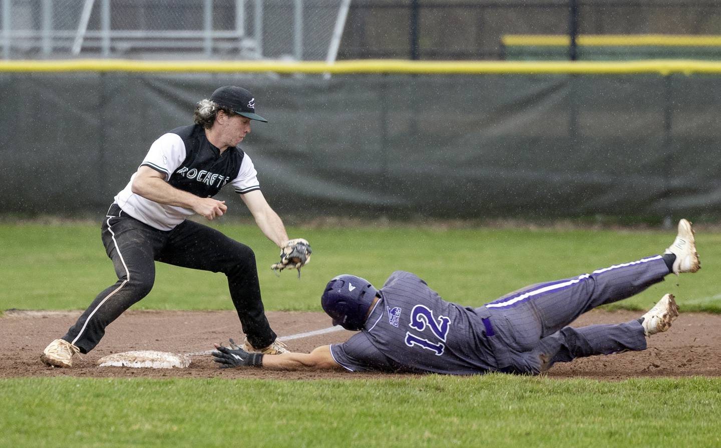 Dixon’s Gage Helfrich steals third as Rock Falls’ Carter Hunter is late on the tag Thursday, April 9, 2026.
