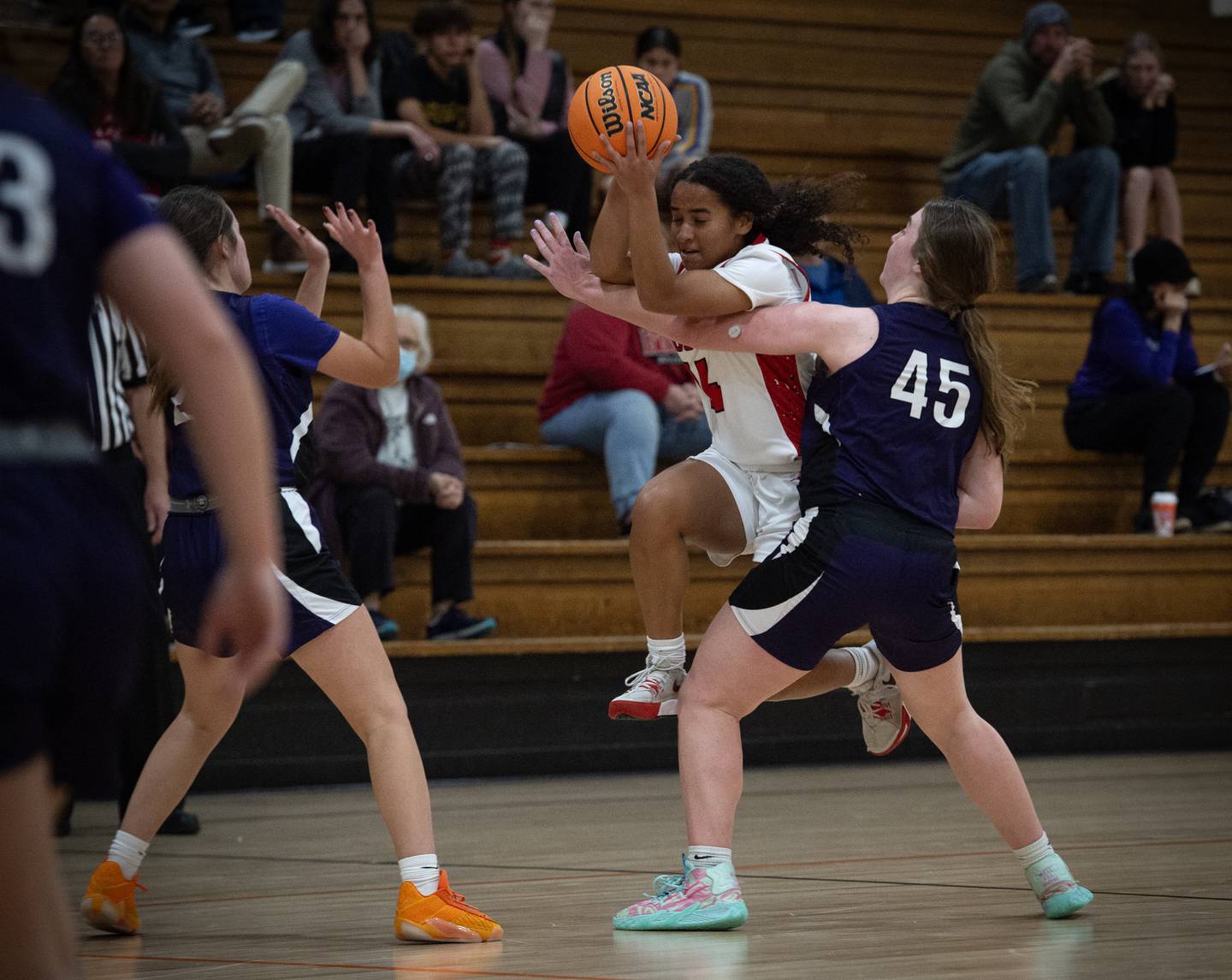 Bradley-Bourbonnais's Nia Lawrence, center, tries to make a drive past Manteno's Emily Horath, right, and Sophie Peterson, left, in the Beecher Fall Classic on Tuesday, November 18, 2025.