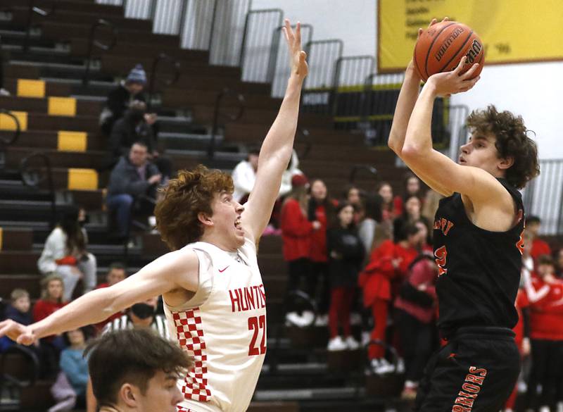 McHenry’s Anthony Fowler, right, shoots the ball over Huntley's Adam Guazzo during a IHSA Class 4A Boys Regional basketball game Wednesday, Feb. 23, 2022, between Huntley and McHenry at Jacobs High School.