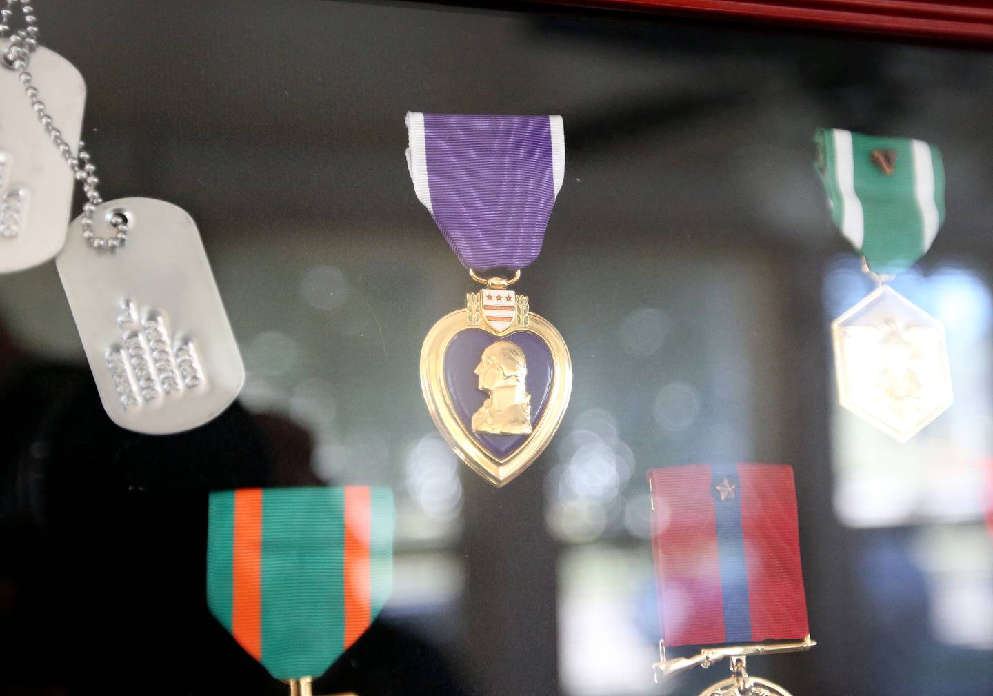 A shadowbox of medals including a Purple Hart given to Veteran Gordon Parks hangs on his wall in his home on Monday, Oct. 7, 2024 in La Salle.