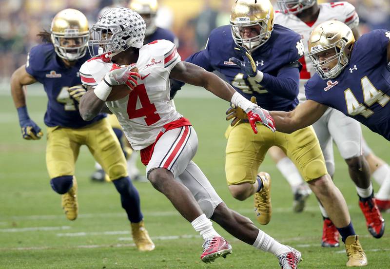 FILE - Ohio State running back Jalin Marshall (7) is pressured by Notre Dame defensive lineman Doug Randolph (44) during the first half of the Fiesta Bowl NCAA College football game on Jan. 1, 2016, in Glendale, Ariz. Notre Dame plays at Ohio State on Sept. 3, 2022. (AP Photo/Rick Scuteri, File)