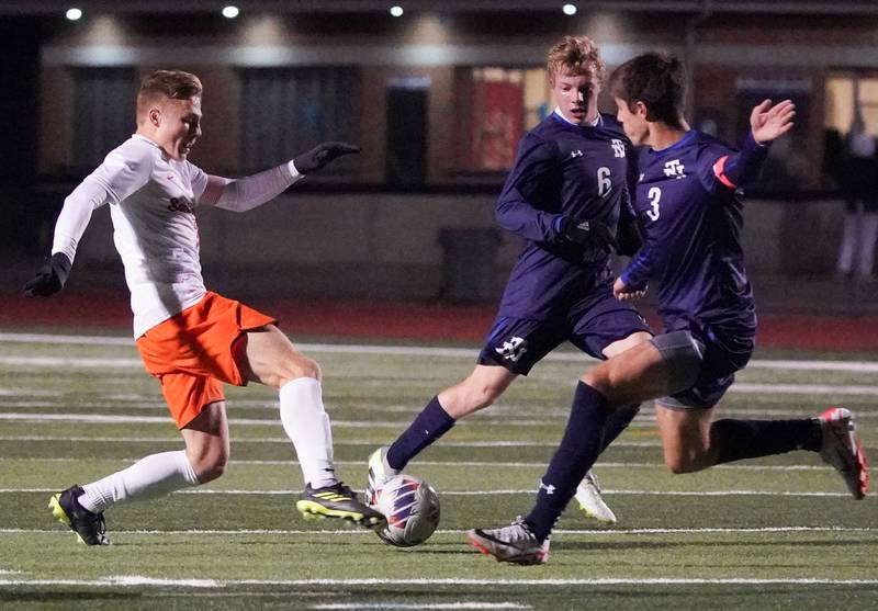 St. Charles East's Logan Lewarchick (left) plays the ball against New Trier's Liam Myers (3) and Ian Vichnick (6) during the class 3A St. Charles North Boys Soccer Supersectional match at St. Charles North High School on Wednesday, Nov. 1, 2023.