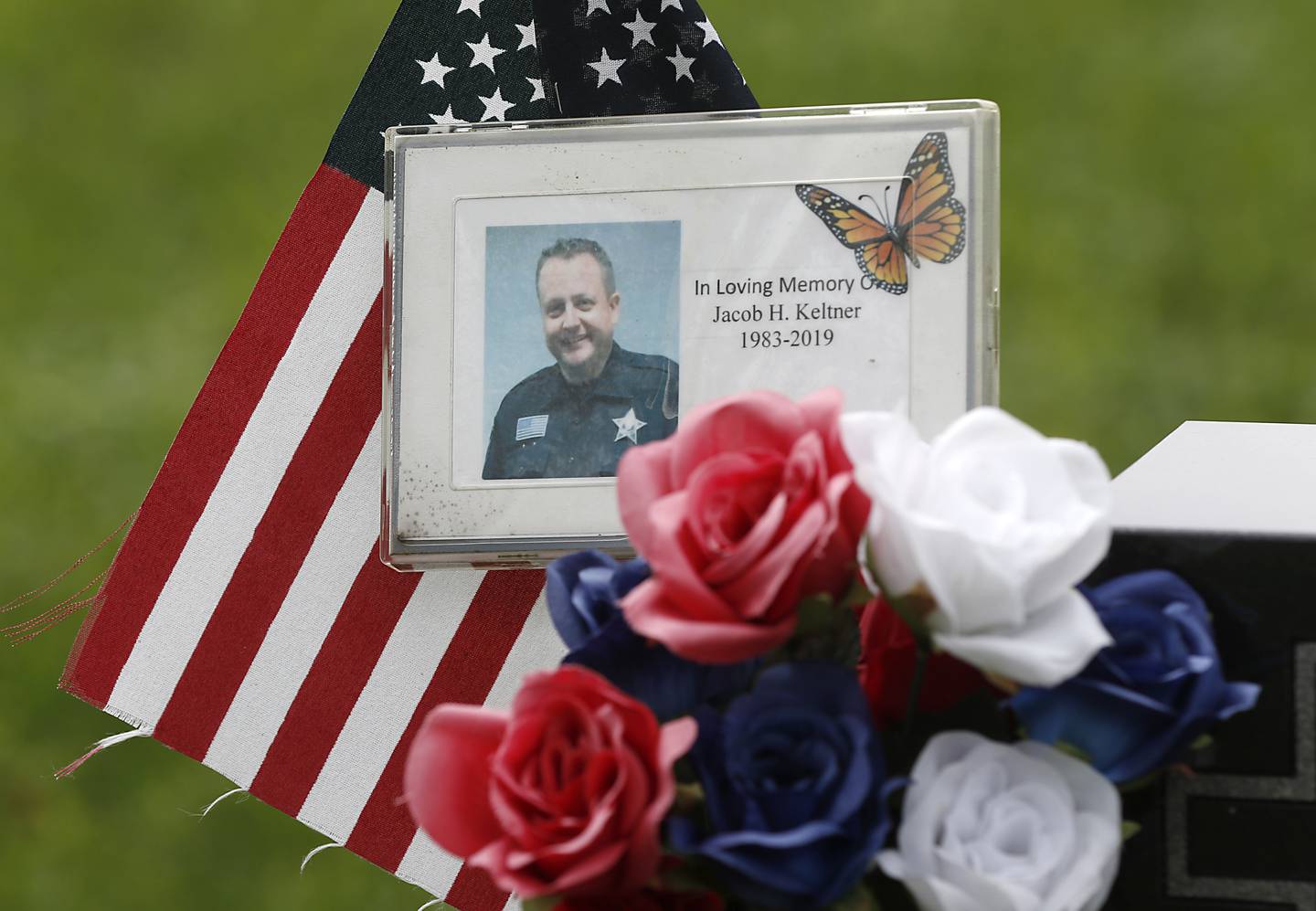 A detail of items left at the headstone for McHenry County sheriff’s Deputy Jacob Keltner, on Monday, Aug. 29, 2022, in Crystal Lake Memorial Park, 8012 Ridgefield Road in Crystal Lake. Keltner was killed in the line of duty while serving an arrest warrant in Rockford in March 2019.