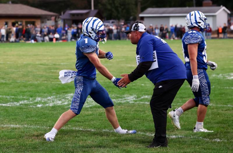 Princeton's Casey Etheridge gets a glad hand from assistant coach Nick Vujanov Friday night at Bryant Field.
