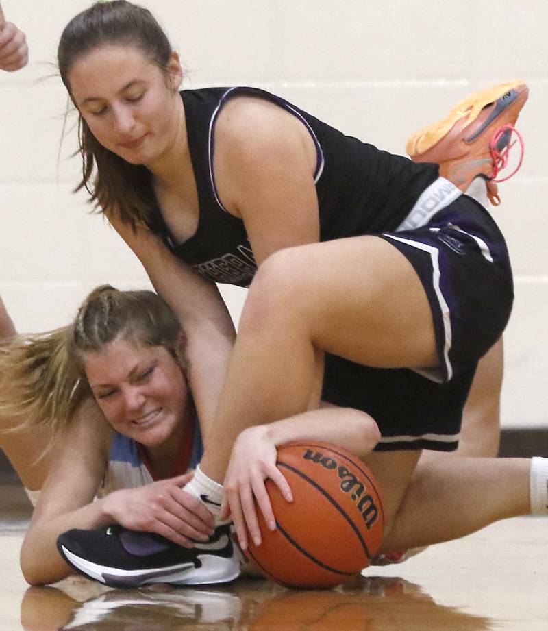 Marian Central's Madison Kenyon battles for a loose ball with Rockford Lutheran's Addie Richard during a non-conference girls basketball game Monday, Dec. 12, 2022, between Marian Central and Rockford Lutheran at Marian Central Catholic High School, in Woodstock.