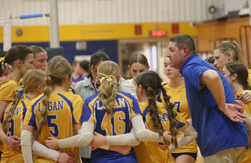 Logan eighth-grade volleyball head coach Andy Puck huddles with his team while playing Rockford-Marshall during the IESA Class 3A eighth-grade Regional final game on Thursday, March 13, 2025 at Logan Junior High School in Princeton.